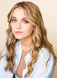 a young woman with long wavy hair and blue eyes